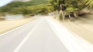 A blurry image of a road with a sign on it video