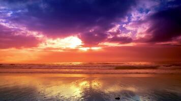 A colorful sunset over the ocean with clouds reflected in the water video