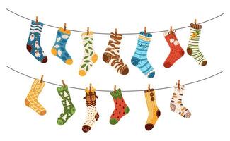 Colorful socks with various patterns hanging on clotheslines flat color illustration. Winter warm footwear laundry cartoon objects on white vector