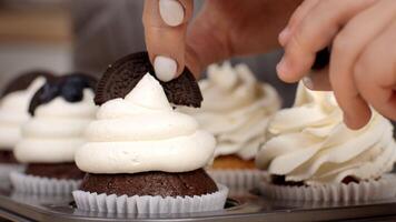 A variety of chocolate and vanilla cupcakes topped with smooth, creamy frosting ready to be enjoyed. video