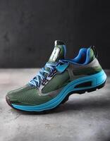 A pair of insulated running shoes on a concrete surface. Sports Shoes photo