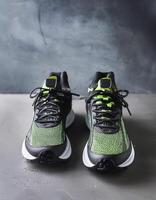 A pair of insulated running shoes on a concrete surface. Sports Shoes photo