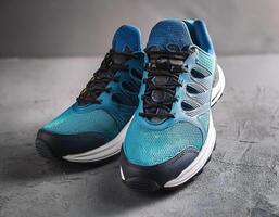 A pair of insulated running shoes on a concrete surface. Sports Shoes photo