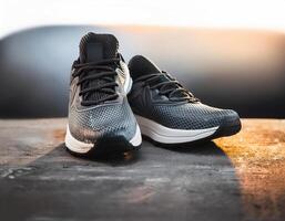 A pair of insulated running shoes on a concrete surface. Sports Shoes photo