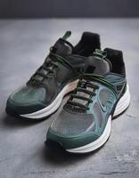 A pair of insulated running shoes on a concrete surface. Sports Shoes photo