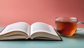 An open book with a cup of tea beside it isolated on minimalist background photo