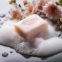 Bar soap is kept on a minimalist background with flowers surrounding it and foam photo