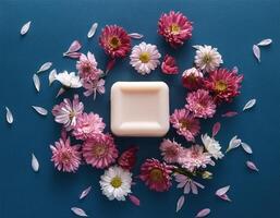 Bar soap is kept on a minimalist background with flowers surrounding it photo
