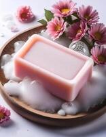 Bar soap is kept on a minimalist background with flowers surrounding it and foam photo
