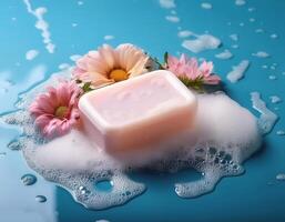 Bar soap is kept on a minimalist background with flowers surrounding it and foam photo