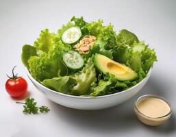 Fresh salad in a white bowl with dressing on the side isolated on a minimalist background photo