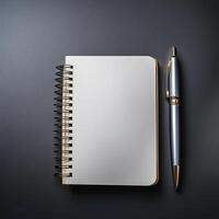 Pen and notebook placed on a clean table photo
