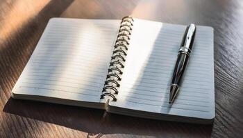 Pen and notebook placed on a clean table photo