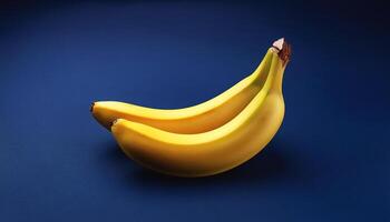 Yellow banana isolated on navy blue background photo