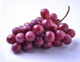 A bunch of purple grapes with one separate grain, focus on the skin texture isolated on white background photo