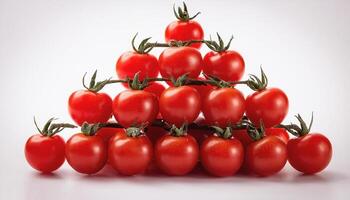 Bright red cherry tomatoes, neatly arranged in a pyramid shape on a white background photo