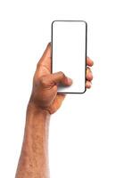 Mockup image of black man's hand holding smartphone with blank screen isolated on white background, copy space photo