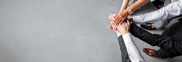 Teambuilding And Unity. Unrecognizable Coworkers Holding Hands Standing In Office. Cropped, Above View, Copy Space photo