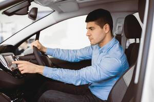 Transport, Destination, Modern Technology Concept. Man searching for route using navigation system on car dashboard screen photo