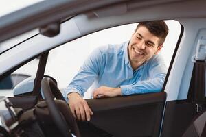 Dream Car. Happy Man Looking At New Auto, View From The Inside Of The Car. Copy Space photo