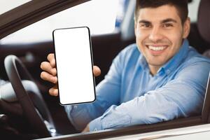 Joyful Businessman Showing Car Key Smiling To Camera Sitting In Driver's Seat In New Automobile Dealership Store photo