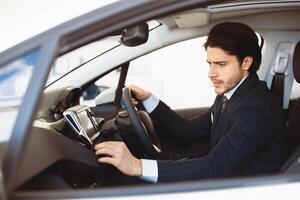 Transportation And Modern Technology Concept. Assistant checking navigation system on car dashboard screen photo
