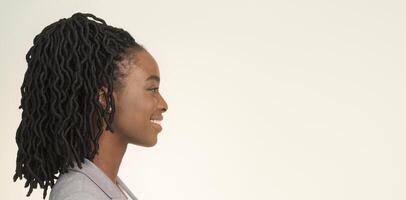 Portrait Of Smiling African American Businesswoman Looking Aside On White Background In Studio. Side View, Panorama, Empty Space photo