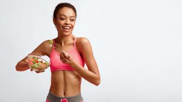 Diet And Weight Loss. African American Fitness Woman Eating Vegetable Salad Smiling To Camera Posing Over Pink Studio Background. Panorama photo