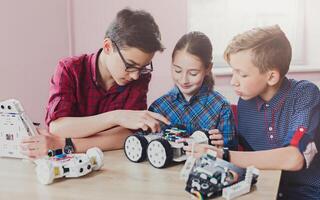 Children creating robots at school, stem education, copy space. Early development, diy, innovation, modern technology concept photo