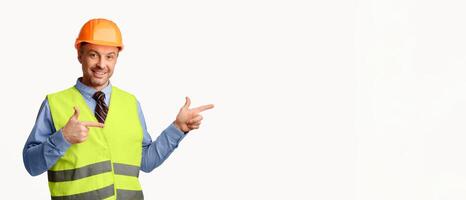 Look There. Construction Worker Pointing Fingers Aside At Empty Space For Text Posing On White Studio Background. Panorama photo