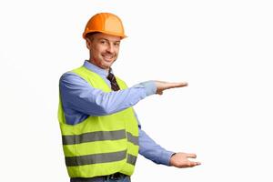 Cheerful Construction Worker Holding Invisible Building Gesturing With Hands Posing On White Studio Background. Free Space photo