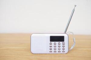 Mini portable radio. Concept, audio electronics for listening to music, songs or news from radio wave channel station. Analog amplifier technology for relaxation and lifestyle. photo