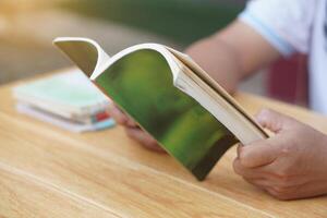 Close up man is reading book. Concept, self study, reading book for knowledge, pleasure or self development to apply knowledge in daily life living. Read for preparing exam. photo