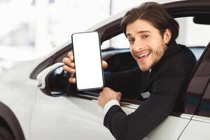 Handsome Auto Vender Showing Car Key Sitting In Driver's Seat Smiling To Camera photo
