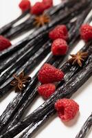 Vanilla beans with raspberries and star anise texture. photo