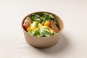 Eggs benedict with bacon and salad photo