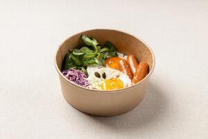 Fried eggs with sausages, red cabbage salad and sauce photo