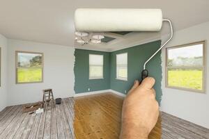 Before and After of Man Using A Paint Roller to Reveal Newly Remodeled Room with Fresh Green Paint, Coffered Ceiling and New Floors. photo