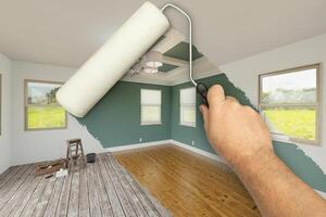Before and After of Man Using A Paint Roller to Reveal Newly Remodeled Room with Fresh Green Paint, Coffered Ceiling and New Floors. photo