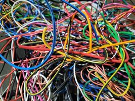 In the garage, after the work of an auto electrician, there are a lot of thin wires, tangled colored wires, intertwined with each other photo