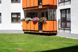 European apartment building, beautiful balcony with flowers in summer. photo