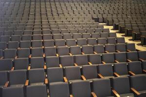 Empty seats in the auditorium. Seats for spectators. Rows of seats. photo