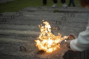 Spraying an aerosol on a flame. Waiting for gas from a spray can. Playing with fire. photo