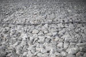 Texture of stones. Stones under the net. Drainage system. photo