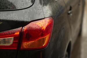 Rain on the car. Raindrops on transport. Wet machine. photo