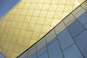 Modern building made of glass and metal. Golden color in architecture of building. Modern style of building. photo