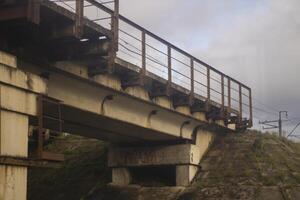 Railway bridge over the highway. Concrete bridge with railway tracks. Transport architecture. photo