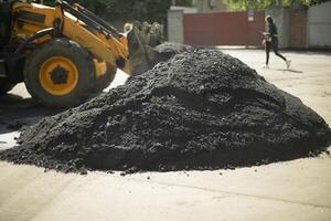 Hot asphalt. The construction of the road. Highway Coating Material. photo