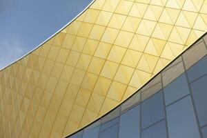 Modern building made of glass and metal. Golden color in architecture of building. Modern style of building. photo