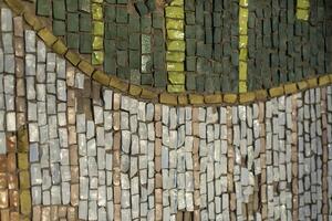 Small tiles. Mosaic on wall. Picture of shards. photo